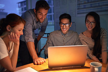 Image showing Teamwork, night and a business group on a laptop, working in the boardroom for planning, strategy or innovation. Meeting, collaboration and overtime with a team of employees at work in the evening