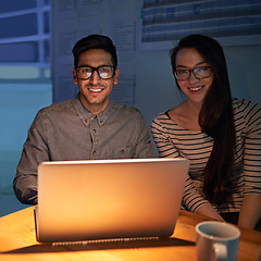 Image showing Portrait, collaboration and night with businesspeople on a laptop, working in the boardroom for planning, strategy or innovation. Meeting, team or overtime with happy employees at work in the evening