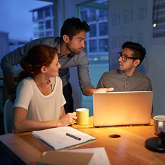 Image showing Planning, night and a business team on a laptop, working in the boardroom for teamwork, strategy or innovation. Meeting, strategy or overtime with a group of employees at work together in the evening