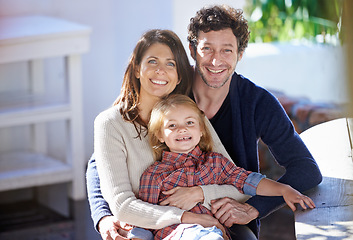 Image showing Family in portrait, mother and father with child in backyard, relax together with love and care outdoor. Happy faces of people outside home, hugging with smile and woman, man with girl in a garden