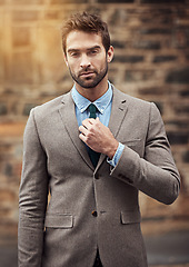 Image showing Stylish businessman, portrait and wall in city with fashion, confidence and success in entrepreneurship. Young business man, entrepreneur or ceo on cbd road, sidewalk or street with focus for mindset