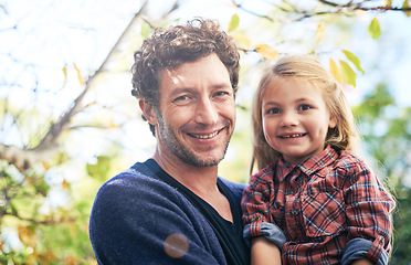 Image showing Happy, nature and portrait of father and daughter in backyard garden for hugging, bonding or affectionate. Happiness, relax and smile with man and young girl in outdoors for embrace, autumn or care