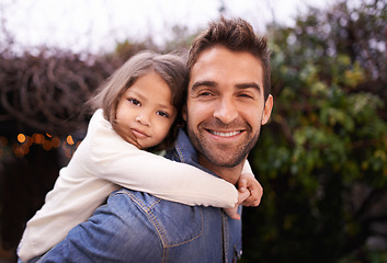 Image showing Happy, piggyback and hug with father and daughter in nature for bonding, family love and affectionate. Smile, relax and happiness with man carrying young child in park for support, weekend and care