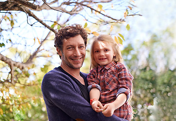 Image showing Happy, hugging and faces of father and daughter under tree in garden for smile, bonding or affectionate. Portrait, relax and excited with man and young girl in outdoors for embrace, autumn and care