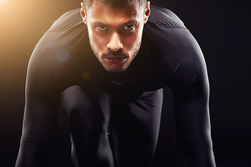 Image showing Runner man, start and isolated portrait or run, race and intense focus in dark studio background. Serious, athlete and running training, cardio and fitness motivation to win, workout or exercise
