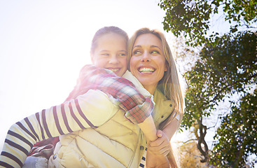 Image showing Hug, piggyback and happy kid, mom or free people enjoy family time, freedom and wellness on bonding walk. Sky, sun flare and youth girl with mother, mama or woman smile for outdoor fun on Mothers Day