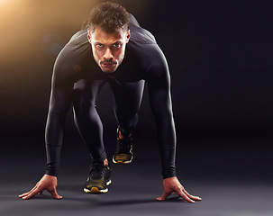 Image showing Man, portrait and runner ready to start, race or intense sport focus in studio background. Serious, professional athlete and running, training or cardio motivation to win, workout or exercise mockup