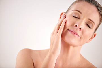 Image showing Senior woman, face and cosmetic wellness or touching her perfect skin on isolated and white background. Mature lady, massaging and wrinkles in facial aging process or skincare and beauty on mock up