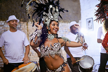 Image showing Carnival, dance and cultural female dancer performing with band at mardi gras or exotic festival. Performance, costume and woman dancing with rhythm to live music for entertainment in Rio de janeiro.