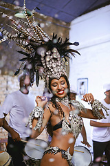 Image showing Celebration, party and exotic female dancer dancing with a band at mardi gras or cultural festival. Performance, costume and woman performing a dance with rhythm to live music at a carnival in Brazil