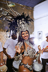 Image showing Dance, portrait and exotic woman dancer performing with a band at mardi gras or cultural festival. Performance, costume and female performer dancing to live music at a celebration carnival in Brazil.