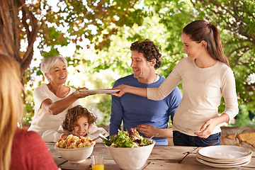 Image showing Food, party and help with family at lunch in nature for health, bonding and celebration. Thanksgiving, social and event with parents and children eating together for dining, generations and wellness