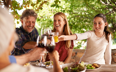 Image showing Family, group and wine glass for toast at table for celebration, food or friends at lunch event. Men, women or smile together to celebrate with alcohol, glasses or solidarity at party, dinner or home