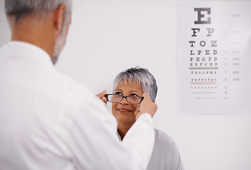 Image showing Optometrist doctor, elderly patient and glasses for vision, eye exam in medical consultation at optometry practice. Prescription lens, frame and senior man help woman in clinic with health insurance