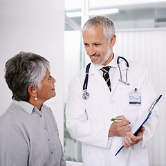 Image showing Elderly man doctor with patient, clipboard for information and medical forms during consultation. Healthcare, old woman at checkup and health insurance with communication and help at doctors office