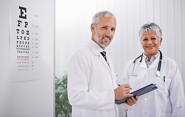 Image showing Team of doctors with clipboard, smile and optometrist with medical paperwork, collaboration and health insurance. Senior man, woman in portrait at optometry practice with information and checklist