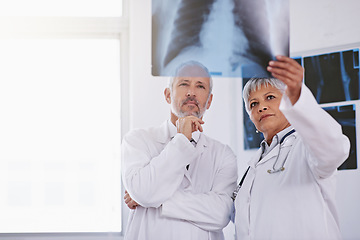 Image showing Senior team of doctors, review xray for surgery and people in radiology, cardiovascular health at clinic. Lung scan, old man thinking about diagnosis and woman surgeon collaboration with assessment