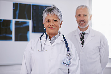 Image showing Senior team of doctors in portrait, smile in radiology with woman in leadership and man in hospital. Surgeon, healthcare and medical professional people in collaboration, happy working together