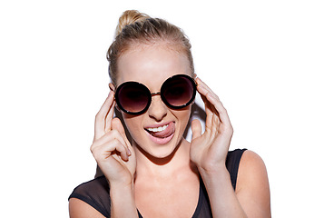 Image showing Portrait, tongue out and sunglasses or trendy woman for fashion in studio or positive and isolated on white background. Face, female model and crazy or smiling hipster or glamour and lipstick