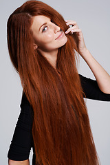 Image showing Red hair, beauty and portrait of woman in studio for keratin treatment, wellness and haircare on white background. Salon, hairdresser and ginger female model with shine, healthy and natural hairstyle