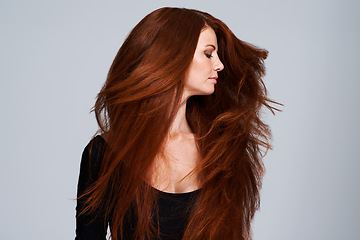 Image showing Red hair, shake and woman in studio for keratin treatment, wellness and haircare on gray background. Beauty, hairdresser mockup and female model with shine, healthy and natural, ginger hairstyle