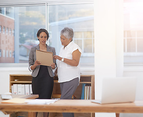 Image showing Business, paperwork and women talking in office for planning, brainstorming or advice. Corporate team or manager and employee together for discussion, collaboration or teamwork on a report or project