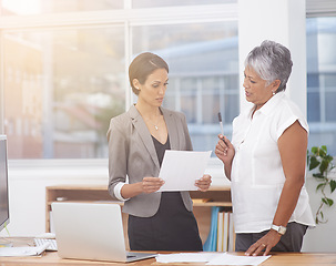 Image showing Paperwork, talking and business women in office for planning, brainstorming or advice. Corporate team or manager and employee together for discussion, collaboration or teamwork on a report or plan