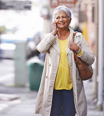 Image showing Phone call, city walk and senior woman talking on cellphone discussion, communication or chat to smartphone user. Urban travel, connectivity and elderly person consulting, commuting or talk on mobile