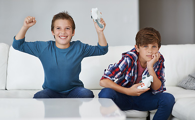 Image showing Boys playing video game, celebrate and friends gaming with tech, esports and entertainment with winner. Gamer kids play games on console at home, happy with win and male children have fun together