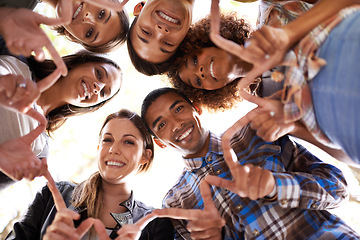 Image showing Portrait, finger star and friends in circle with diversity, unity and collaboration with low angle. Happy, smile and group of people in huddle together with hand gesture for solidarity and community.