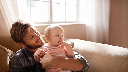 Image showing Smile, father and hug baby on sofa in home living room, playing or bonding together. Happiness, care and dad embrace infant, newborn or child on couch in lounge, having fun and enjoying quality time.