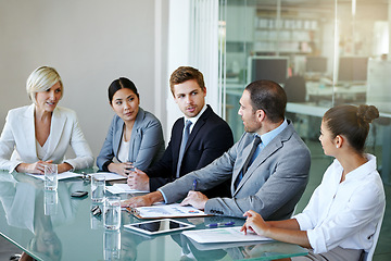 Image showing People in a business meeting, teamwork and discussion in conference room with diversity in corporate group. Men, women and project planning with conversation, paperwork and collaboration in workplace