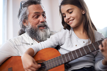 Image showing Girl with grandfather, happy with guitar and learning to play, music education and creative development. Musician, art and old man helping female kid learn focus and skill on musical instrument