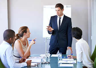 Image showing Business man, workshop speaker and meeting of a corporate management team with financial data. Speaking, businessman and collaboration of accounting staff working in a conference room with strategy