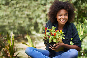 Image showing Black woman in garden, smile in portrait with gardening and plant or flower, botany and young gardener outdoor. Happy female person with growth, environment and plants out in nature with landscaping