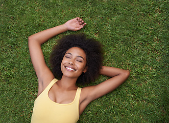 Image showing Sleeping, grass and mockup with a black woman lying on a field from above for peace or quiet outdoor in nature. Dream, relax and zen with an attractive young female resting alone in the countryside