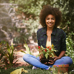 Image showing Black woman with plant in garden, smile in portrait with gardening and flower, botany and young gardener outdoor. Happy female person with growth, environment and plants in nature with landscaping