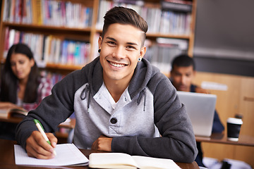 Image showing Education, writing and happy with portrait of man in library for study, research or classroom quiz. Focus, learning and notebook with male student at university for knowledge, scholarship and project