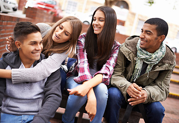 Image showing University, friends and people on campus in conversation, talking and chat outdoors on steps. Diversity, education and happy men and women students relax and bonding on school, academy and college