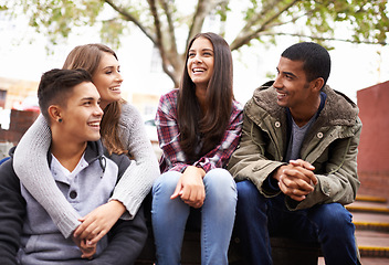 Image showing University, happy and friends on campus stairs in conversation, talking and chatting outdoors. Diversity, education and happy men and women students for social bonding on school, academy and college