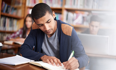 Image showing Study, writing and school with man in library for education, research and classroom quiz. Focus, learning and notebook with male student on university campus for knowledge, scholarship and project