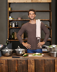 Image showing Chef, man akimbo and portrait in kitchen while making delicious food for healthy diet and nutrition. Cooking, confidence and male cook standing in rustic restaurant or small business in Canada.