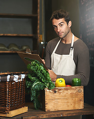 Image showing Chef, checklist and portrait of man in restaurant with vegetables for vegetarian or vegan ingredients. Serious, male cook with clipboard and food from Norway for cooking in kitchen or small business.