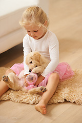 Image showing Child, golden retriever and playing at home with a dog and happy girl together for love, care and development. Cute kid and animal puppy or pet playing dress up game as friends on the lounge floor