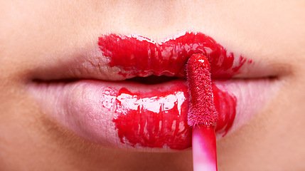 Image showing Woman lips, red lipstick and brush, makeup and beauty closeup with bold color and cosmetics. Vibrant aesthetic, creativity and mouth of female model with cosmetic product, cosmetology and lip gloss