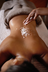 Image showing Salt sprinkle, back scrub and spa specialist hands with woman customer at a hotel with massage. Exfoliate therapy, luxury and relax treatment of a female person rest for skincare and wellness