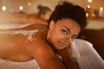 Image showing Salt, spa application and black woman portrait of customer at a hotel with lying for massage. Exfoliate therapy, luxury and relax treatment of a female person back for skincare and wellness