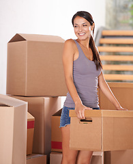 Image showing Smile, young woman and packing boxes for new home owner or parcels for logistics and client moving house. Freight, cargo and lady at property with a package from a courier or shipping for real estate