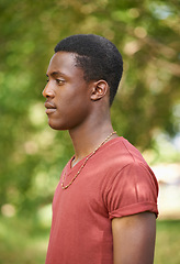 Image showing Profile, teen boy and outside in garden with bokeh blurred background or African teenager, nature and forest, park or calm summer. Young male person, serious face and green, trees or spring sunshine