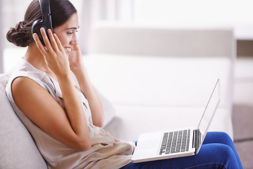 Image showing Woman, laptop and headphones on sofa with smile for online education, music or learning on web in home. Student girl, computer and happy for webinar, development and listen on couch with mockup space